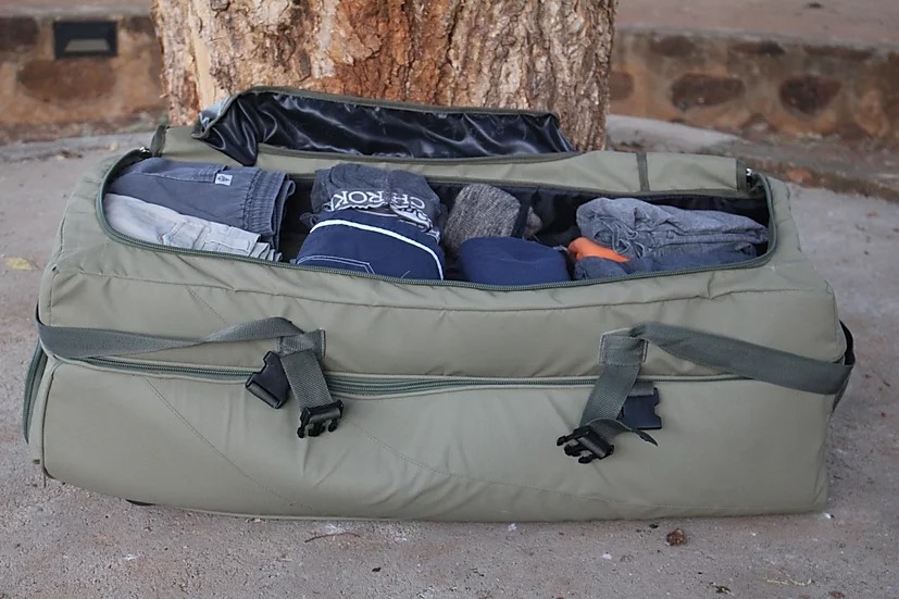 Travel bag open and packed with clothing